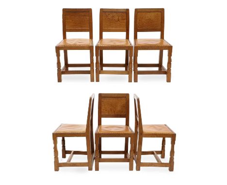 Workshop of Robert Mouseman Thompson (Kilburn): A Set of Six English Oak Panel Back Dining Chairs, upholstered leather seats,