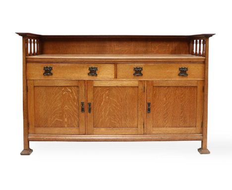 An Arts &amp; Crafts Scottish School Oak Sideboard, the top with raised upstand/shelf, above solid back and pierced heart sid