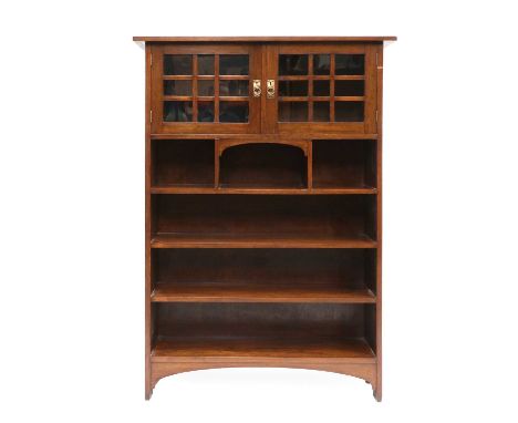 An Arts &amp; Crafts Scottish School Mahogany Bookcase, the rectangular top above two glazed doors with antique brass lacquer