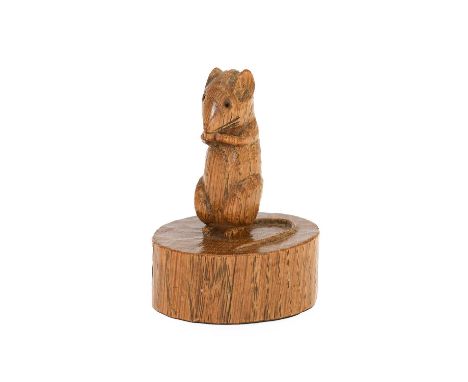 Robert Mouseman Thompson (1876-1955): An English Oak Mouse on a Cheese, the mouse carved on it's haunches on a circular truck