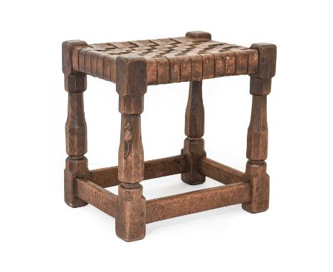 Robert Mouseman Thompson (1876-1955): An English Oak Stool, circa 1930s, strap leather top, on four octagonal legs joined by 