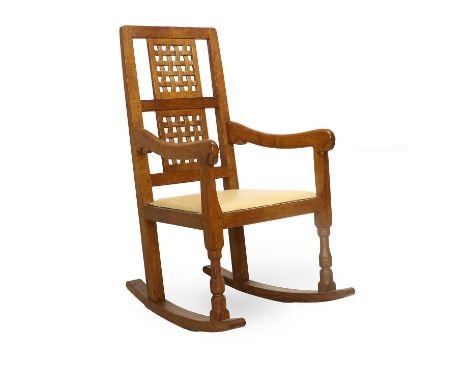 Workshop of Robert Mouseman Thompson (Kilburn): An English Oak Rocking Chair, with two lattice panel back, shaped arms and le