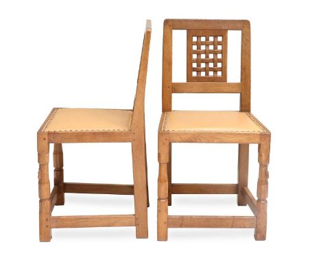 Robert Mouseman Thompson (1876-1955): A Pair of English Oak Lattice Back Dining Chairs, upholstered leather seats, on two oct
