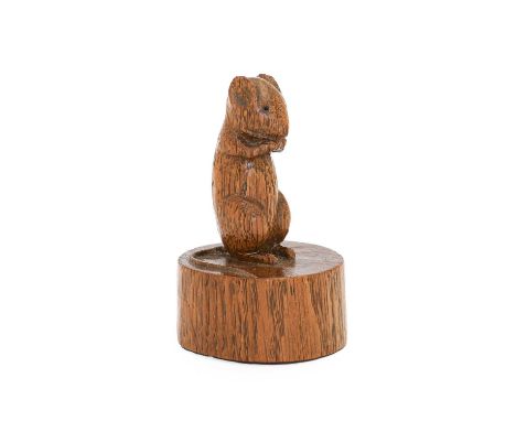 Robert Mouseman Thompson (1876-1955): An English Oak Mouse on a Cheese, the mouse carved on it's haunches on a circular truck
