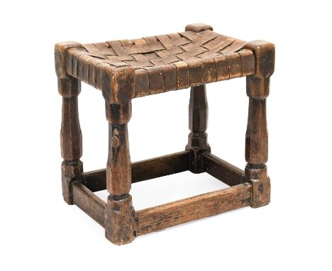Robert Mouseman Thompson (1876 - 1955): An English Oak Stool, circa 1930s, strap leather top, on four octagonal legs, joined 