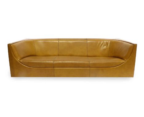 Jorge Zalszupin (Brazilian, 1922-2020): A Cubo Sofa, 1970s, with curved seat, upholstered in stitched tan leather, on square 