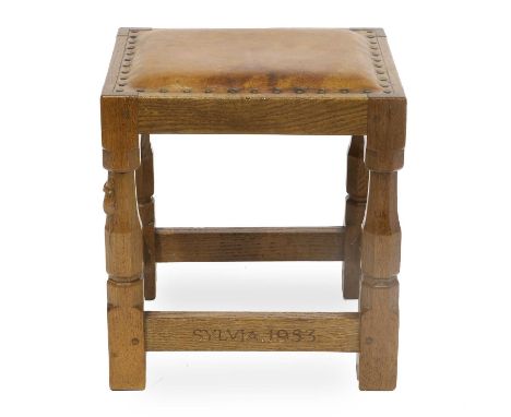Robert Mouseman Thompson (1876-1955): An English Oak Stool, 1953, upholstered leather seat, on four octagonal legs joined by 
