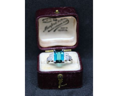 Art Deco Unmarked White Metal Tourmaline and Diamond Ring.  The ring contains a Rectangular Cut-Cornered Step Strong Blue Gre