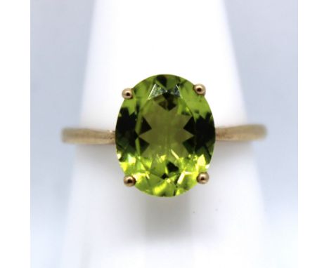 9ct Yellow Gold Peridot Ring.  The Oval Brilliant Cut Peridot is approx. 10.90mm height x  approx. 8.94mm width.  The ring is