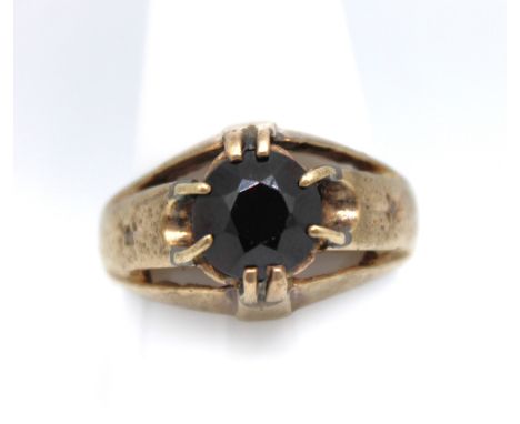 9ct gold and garnet ring.  The garnet is dark red in colour and approx 18mm diameter set in an eight claw setting. There is a