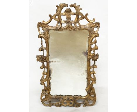 WALL MIRROR, early 18th century George II, Chippendale period carved giltwood with fruit and 'C' scroll carving, 101cm H x 56