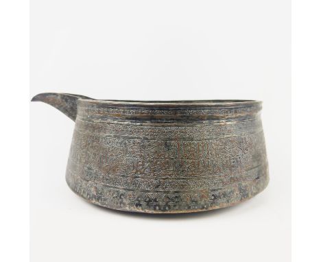 A MAMLUK TINNED COPPER POURING VESSEL, spouted with engraved calligraphy inscription band, 40cm D x 14cm H.