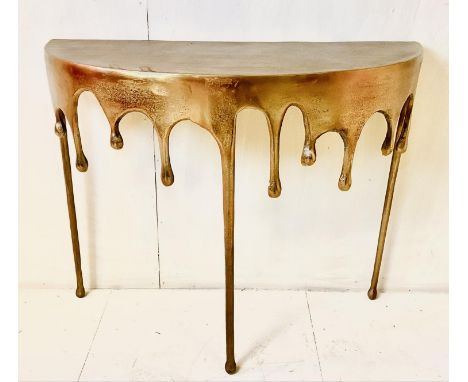 DEMI LUNE CONSOLE TABLE, gilt metal with surrealist dripping design, 76cm H x 90cm W x 33cm D.