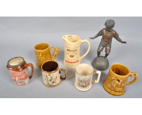 Four ceramic tankards of sporting interest, another a bells whisky wade TPM advertising jug and a resin figure