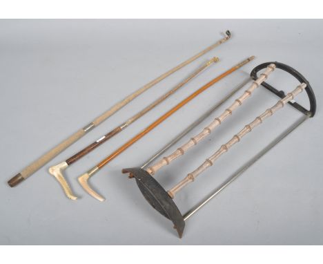 A small stick stand with bamboo uprights, together with three riding crops (4)