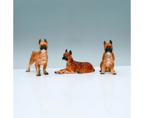 A set of 3 brown ceramic bullmastiff figurines in different poses consisting of one seated, one standing, and one lying down 