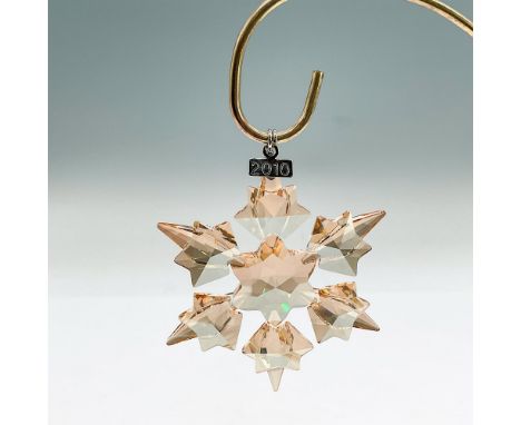 Dazzling star or snowflake shaped tree ornament in goldtone crystal. Swarovski mark. This item has its original box: 5.5"L x 