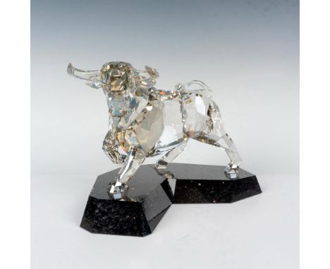 A beautiful clear crystal depiction of a bull in a poised and majestic stance while on top of a granite base. Swarovski backs