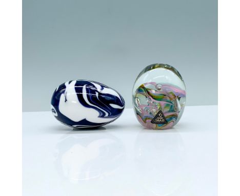A pair of 2 glass paperweights, one is a Kerry Glass paperweight that is clear with spirals of blue, pink, and lavender color