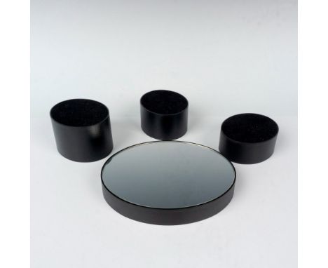 A set of four Swarovski displays that has one oval mirror stand and 3 velvet covered stands in various heights designed for W