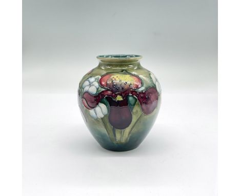 Pretty small vase decorated with colorful flowers in tones of dark red, light blue and yellow with sage green into blue backg