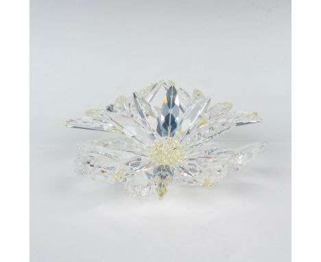 Three clear crystal flowers on a crystal base, the centers of each flower filled with small light-yellow crystals. Swarovski 