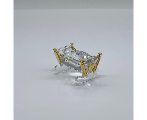 Part of the Childhood Dreams group. Clear crystal figure with gold metal trim. Swarovski marked. This item has its original b