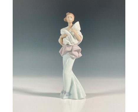 Glossy finish figure of a lady in a light blue mermaid style dress with white shawl. Lladro backstamp. This item has its orig