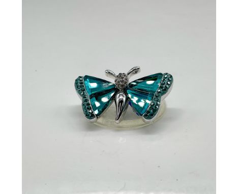 Pin designed with rhodium back, butterfly body, antennae and sides, which holds the indicolite (blue) crystal and rhinestone 