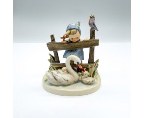 Hand-painted figurine depicting a young girl watching a swan swimming with ducklings while a bird sings on the fence post. Go