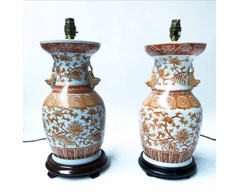 TABLE LAMPS, a pair, Chinese ceramic terracotta foliate design of open vase form with handles, 49cm H with shades. (2)