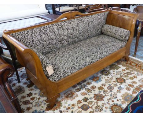 SOFA, mid 19th century Biedermeier walnut with a scrolling carved show frame and leopard print upholstery with twin bolster c