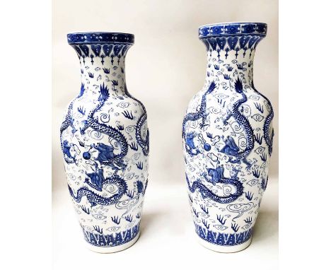 DRAGON VASES, a pair, blue and white Chinese ceramic tall vase form with dragon motifs. (2)