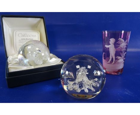 Caithness 'Jubilee Moonflower' paperweight, no.1986, boxed, another paperweight and a Mary Gregory beaker (3) 