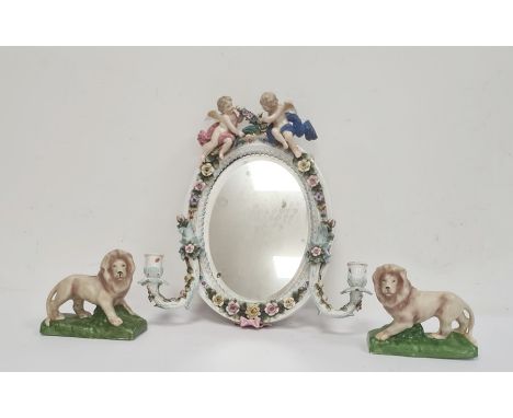 Late 19th century Sitzendorf porcelain oval mirror with candle sconces, decorated with a pair of cherubs, encrusted with flow