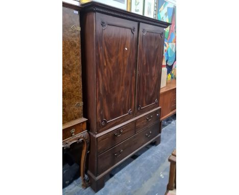 19th century mahogany linen press, the ogee moulded cornice above Greek key decoration, two doors enclosing linen shelves, ab