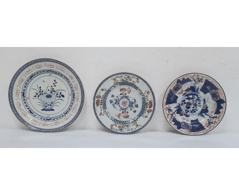 Three various Chinese porcelain plates, variously decorated in principally iron-red and blue, with flowers and buildings (3) 