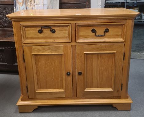 Modern oak cabinet, the rectangular top with canted corners, two drawers, two cupboard doors, bracket feet