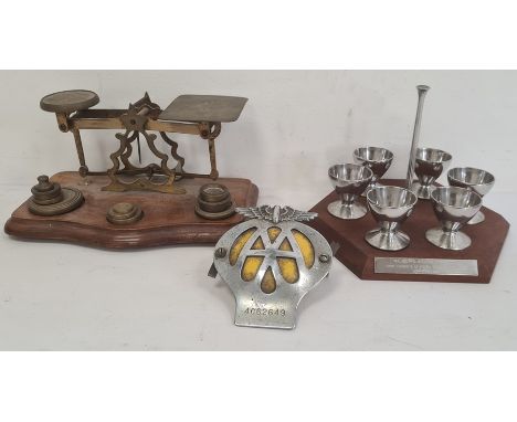 Pair of postal scales on mahogany base with brass weights and a set of chrome eggcups , a enamel and chrome AA badge, No. 436