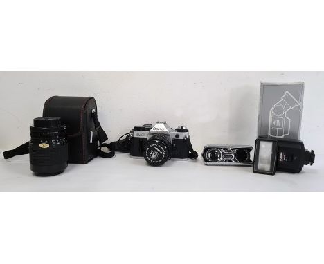 Canon AE1 Programme camera, a Sigma Zoom 1-4/5.6 lens, compact pair of binoculars and one other itemCondition ReportAppears t