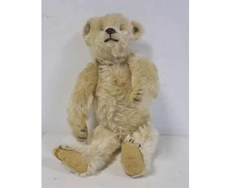 Miniature Steiff teddy bear with stud to ear, 22cm long approx, boot button eyesCondition ReportThe bear has both eyes presen