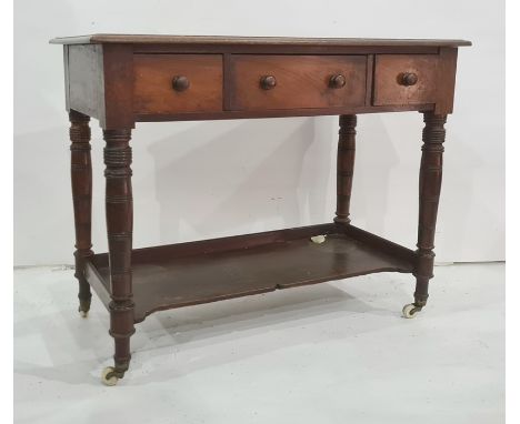 19th century mahogany washstand, the rectangular top with moulded edge above three drawers, on turned ring supports, shelf an