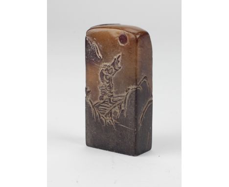 A tall Chinese carved soapstone Seal, with figure on bridge and another figure by pagodas, 3 1/4" (9cms). (1)