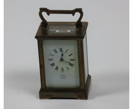 A small heavy brass cased Carriage Clock, the white enamel dial signed Dent, Pall Mall, London, with five bevelled glass pane