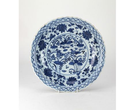 A rare Chinese blue and white floral barbed scroll Dish, with lattice design edge and scrolling flowers, the centre roundel w