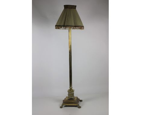 A heavy brass Corinthian column Lamp Standard, with cream pleated shade on a base with ball n' claw feet. (1)