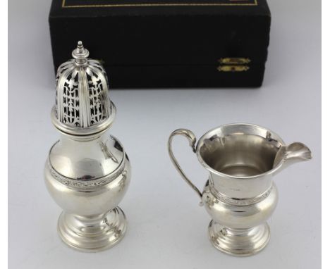 A cased Presentation silver Sugar Castor and Cream Jug, decorated in the Celtic taste, by S. Blanckensee &amp; Son Ltd., c. 1