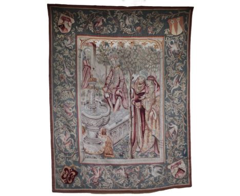 A 19th Century French Tapestry, depicting medieval figures in a garden by a fountain, inside a floral border with birds, each