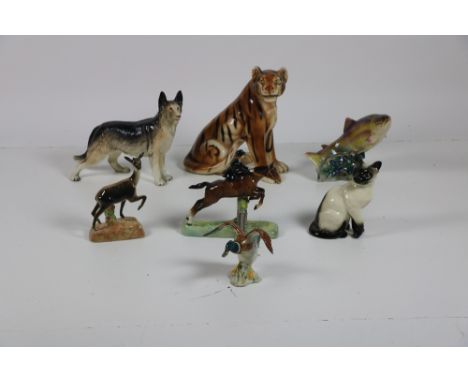 A large and attractive collection of Beswick Figurines, including fish, deer, dogs, cats, and ducks, all of various sizes and