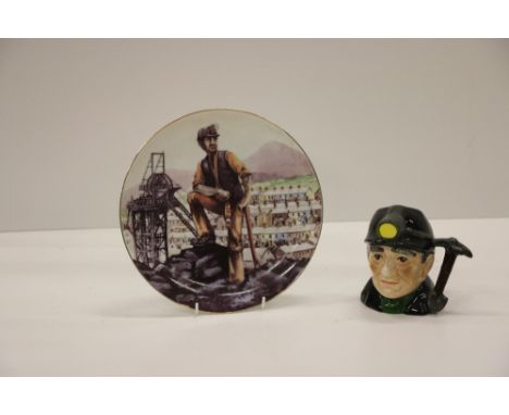 A Shorter &amp; Son, Stoke on Trent porcelain Mug, of a miner with hardhat and pick axe as handle; together with a painted tr